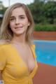 A woman in a yellow dress posing by a swimming pool.