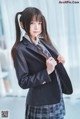 A young woman in a school uniform posing for a picture.